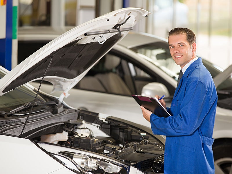 Image of Service Manager working on car